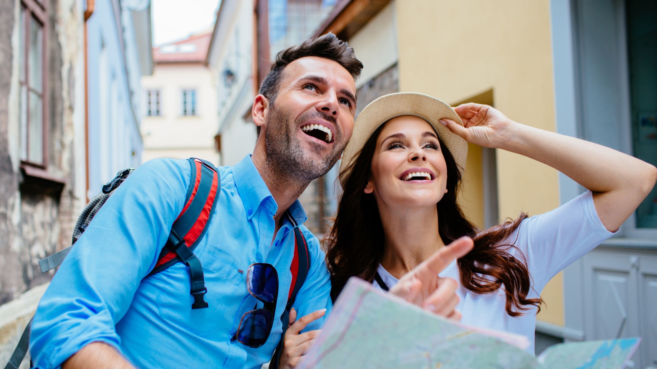 A smiling couple sightseeing in a city they are visiting
