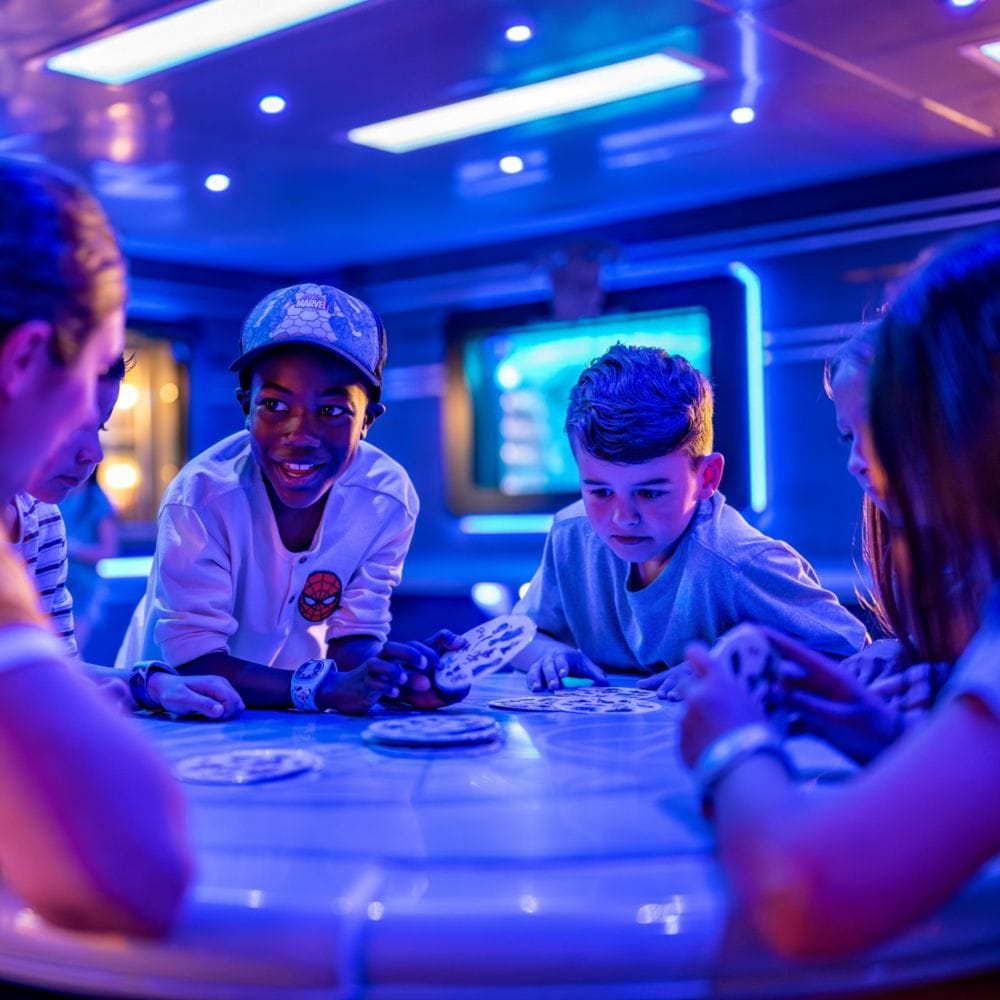 Young kids in a lounge playing a card game