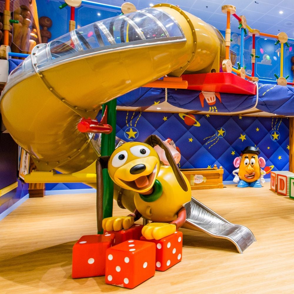 A room themed like the film Toy Story with Mister Potato Head, Slinky Dog and a structure to climb through