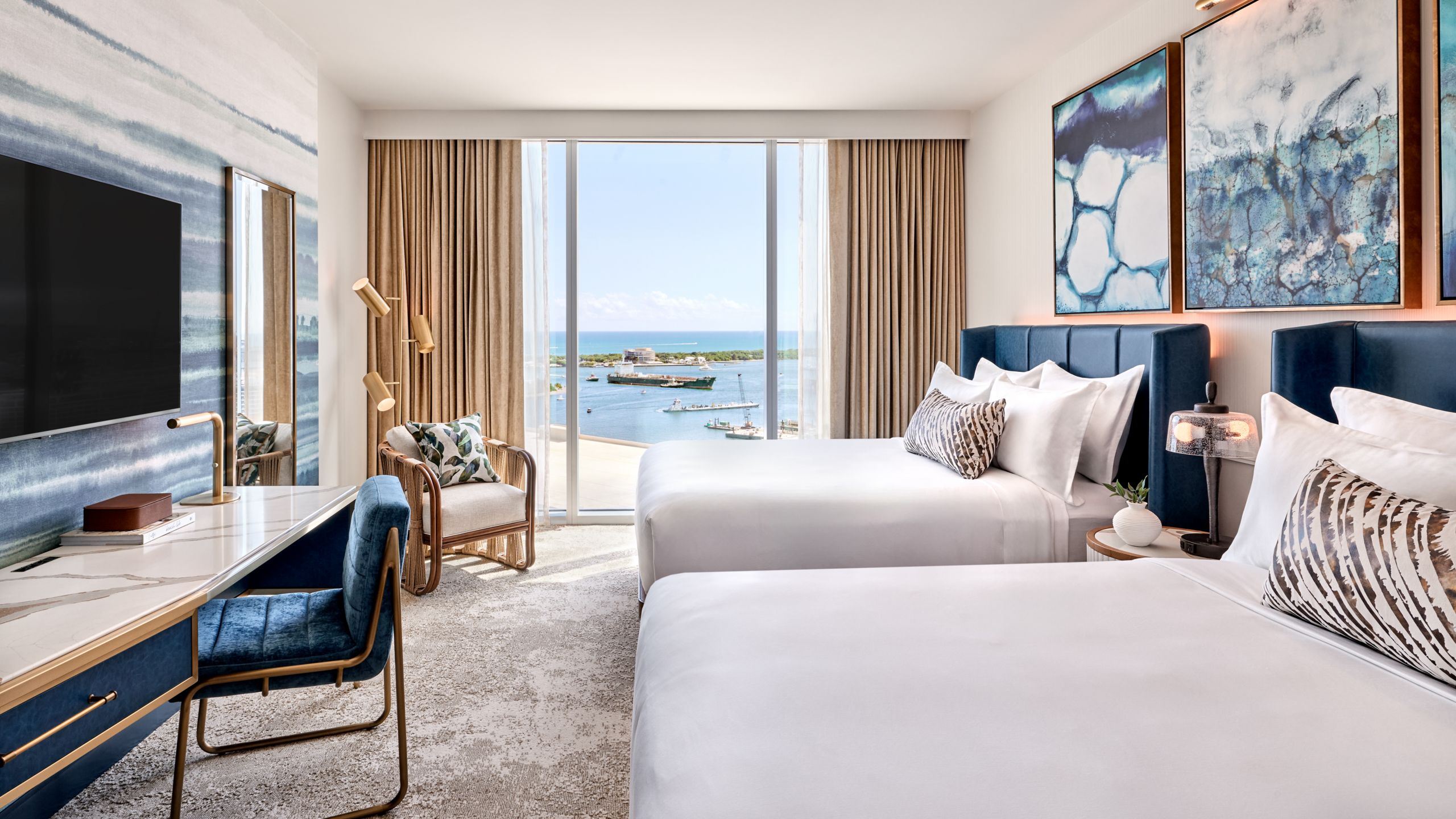 A room at Omni Fort Lauderdale Hotel with 2 beds, a desk, a flat panel TV and a view of a harbor