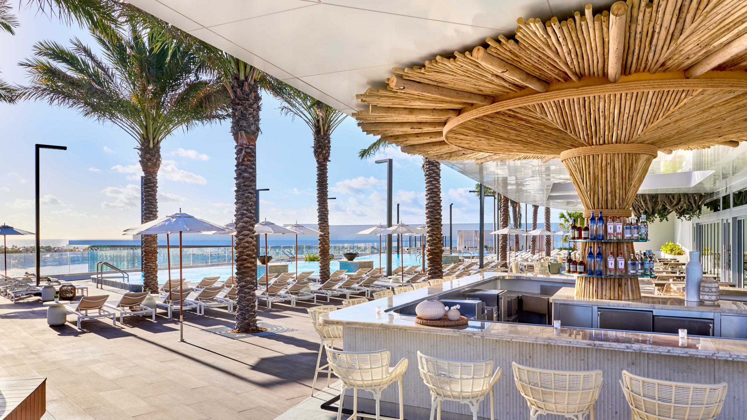 Tide Coastal Kitchen, a poolside bar decorated with thatched bamboo at Omni Fort Lauderdale Hotel in Florida