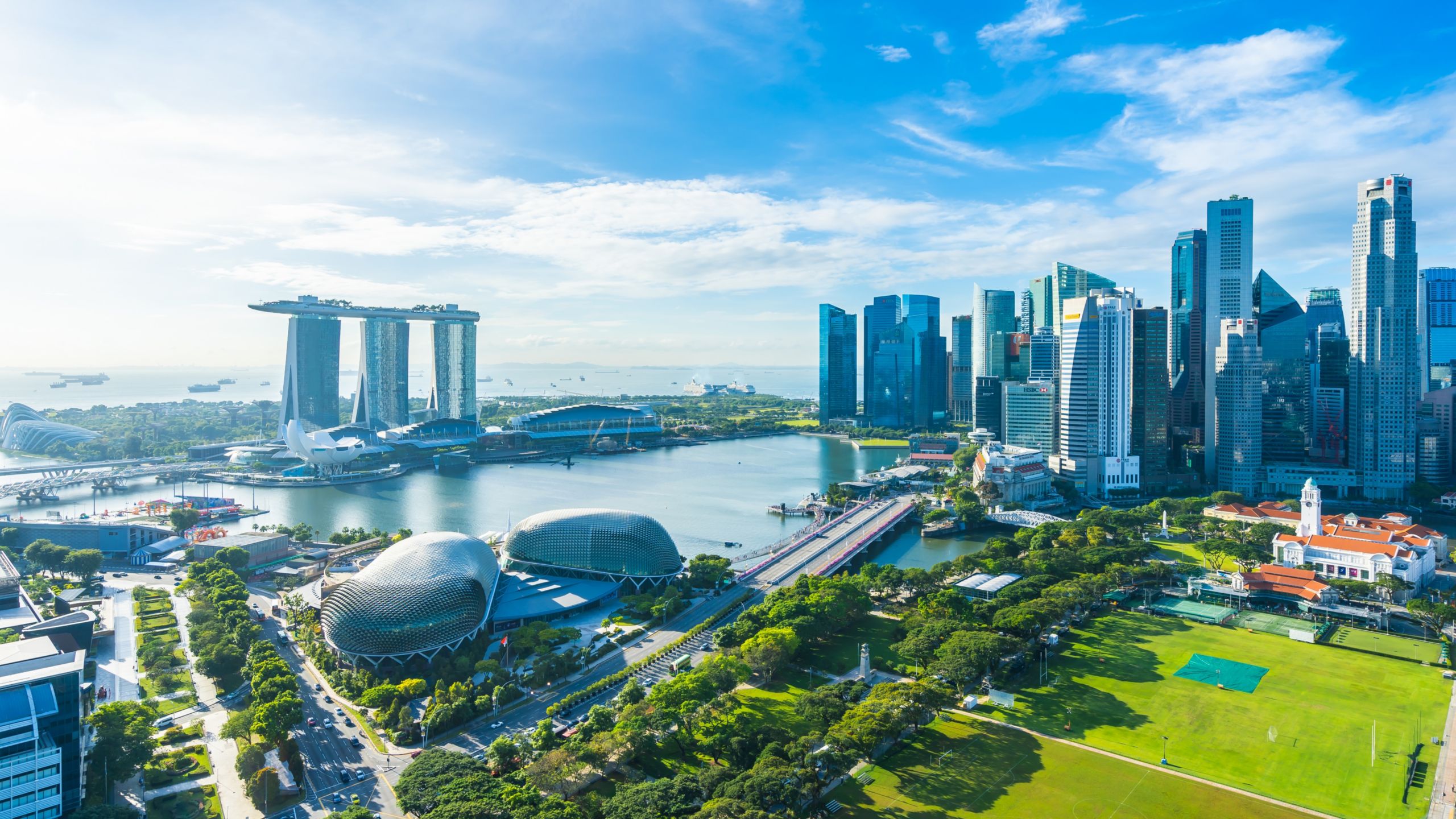 The Marina Bay Sands Singapore Hotel, the Esplanade Concert hall, athletic fields and the city skyline at Marina Bay