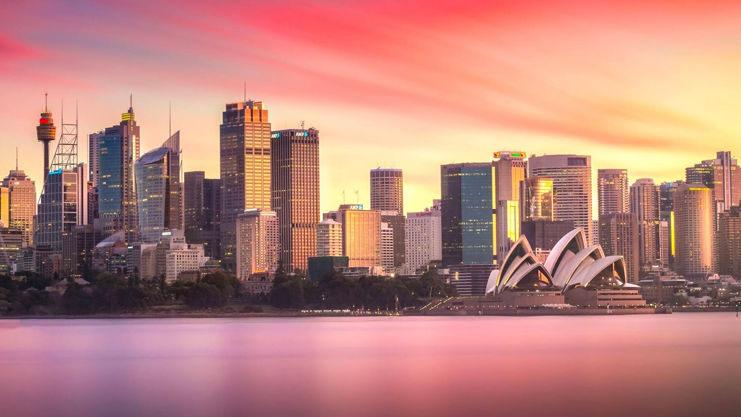 Sydney Harbour and the Sydney Opera House next to an array of modern glass and steel skyscrapers