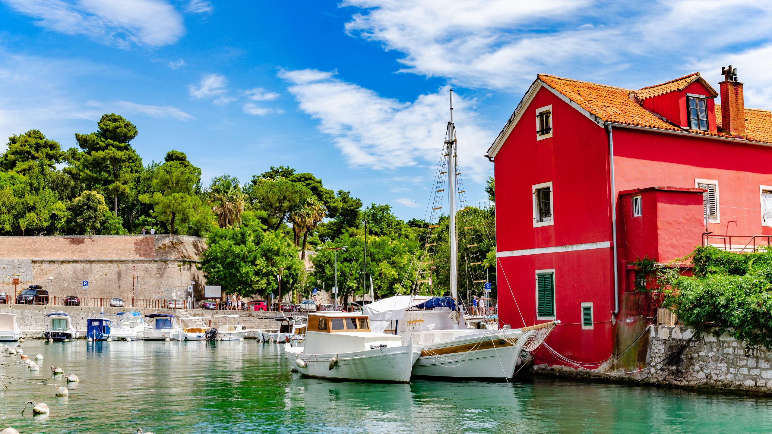Boats docking in the harbor next to the Restaurant Foša near Zadar’s old city walls