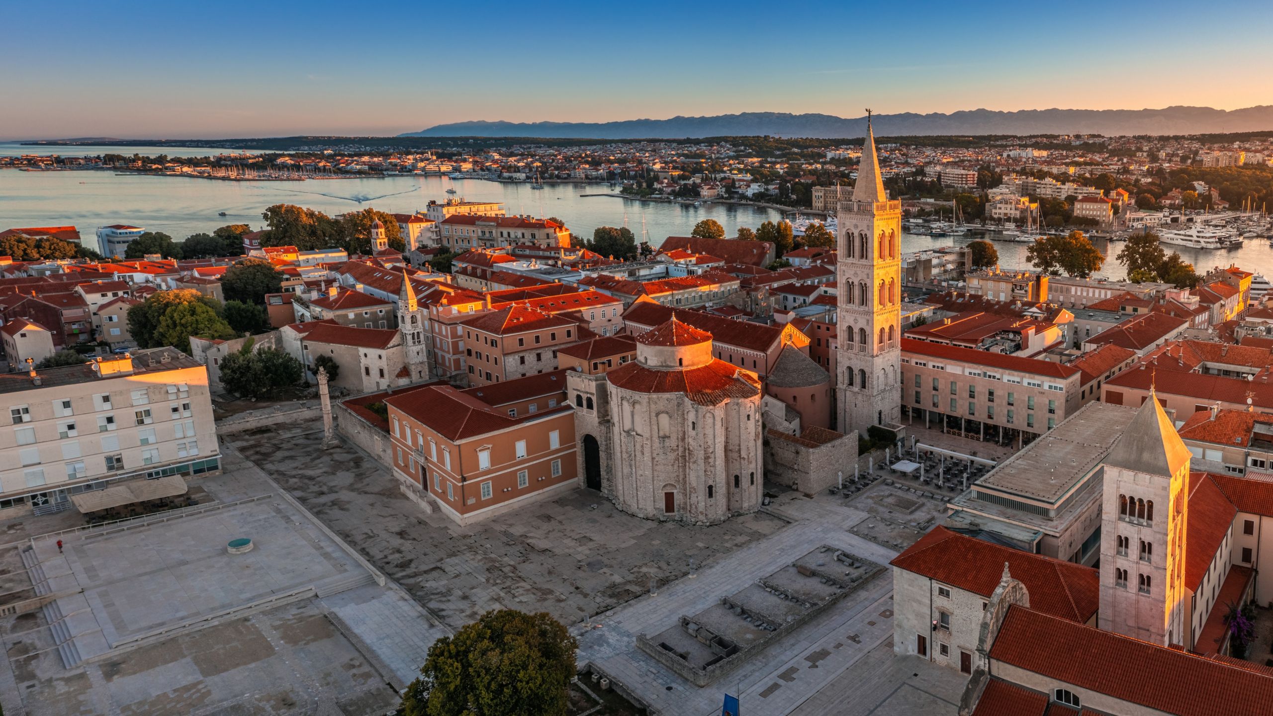 Zadar’s Roman Forum with Saint Donatus Church and Saint Anastasia Cathedral bell tower at sunset