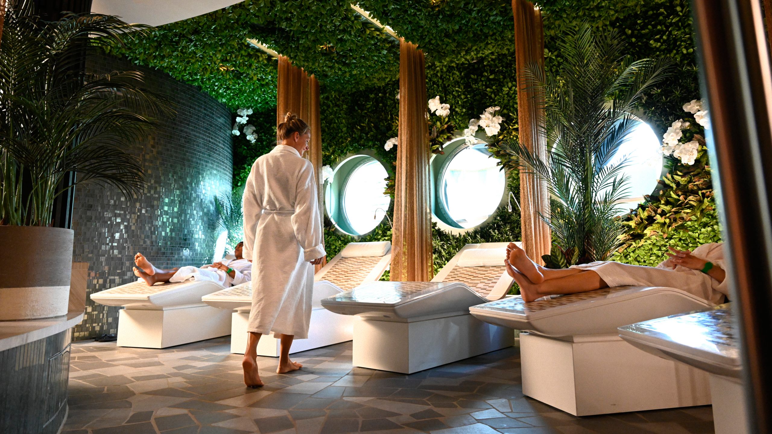 Guests relaxing in a spa setting decorated to look like a rainforest