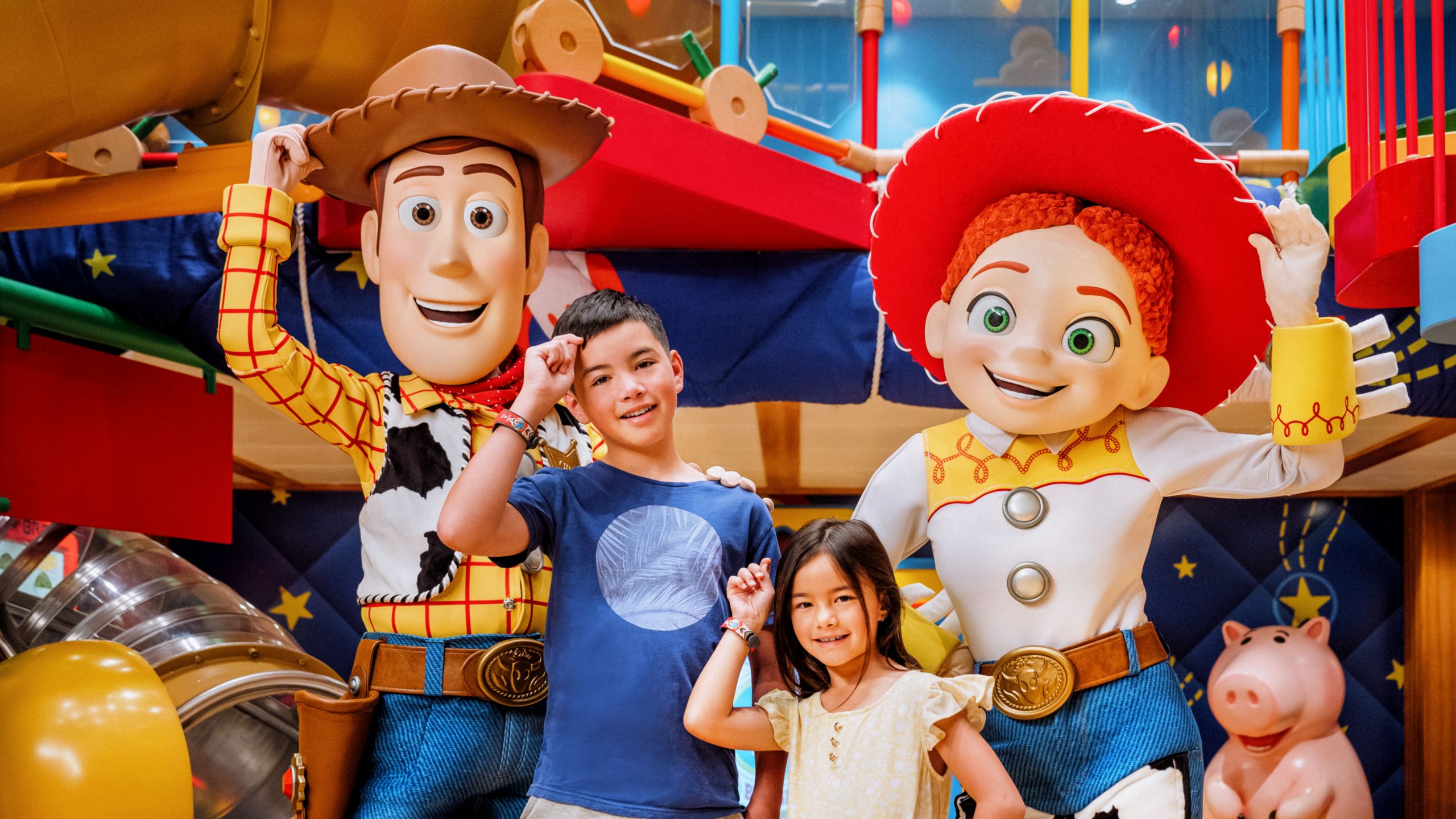 Two children posing with Woody and Jessie at Andy’s Place in Disney’s Oceaneer Club