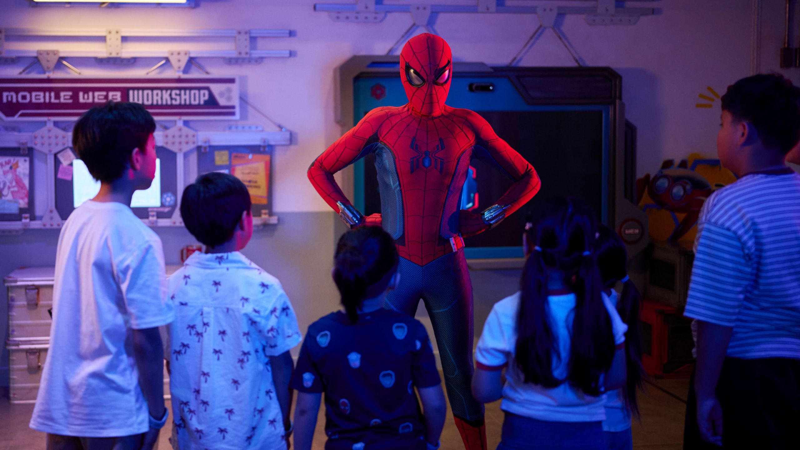 Spider Man facing a group of young kids aboard the Disney Adventure cruise ship