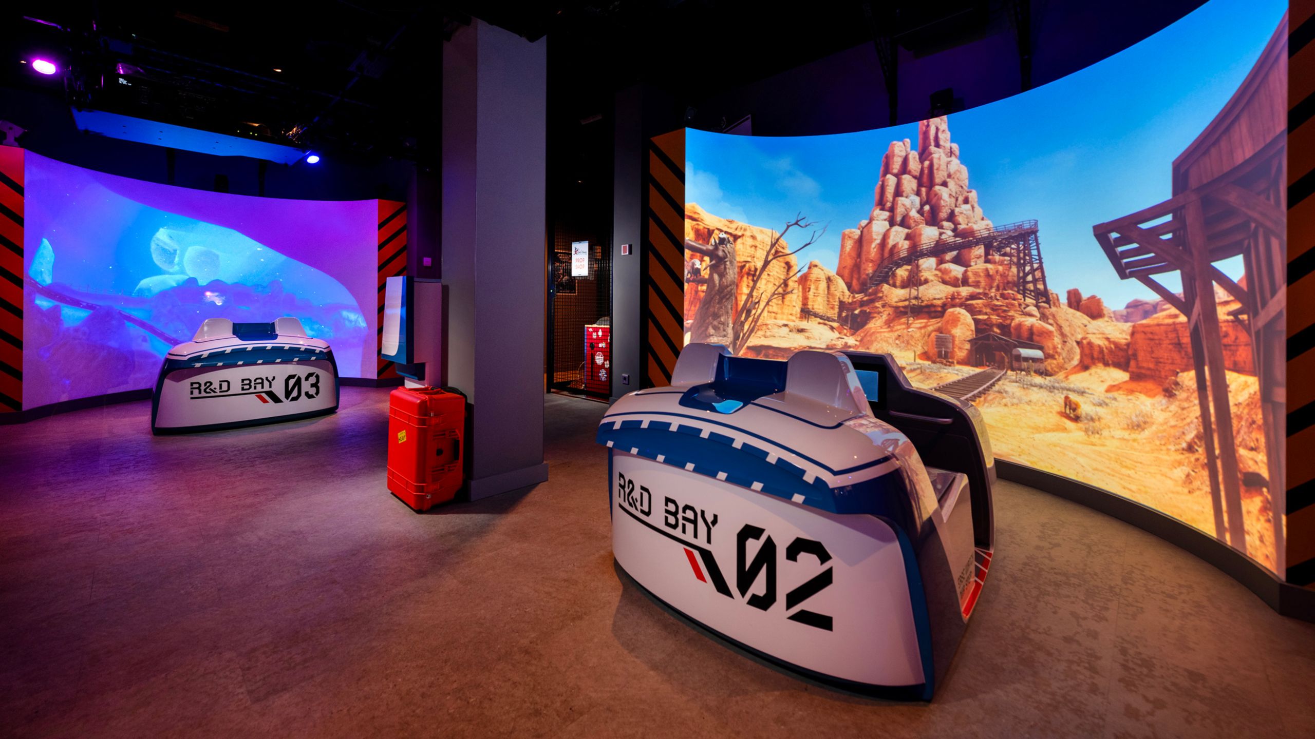 Two large screens with immersive seating at the Walt Disney Imagineering Lab aboard the Disney Adventure cruise ship