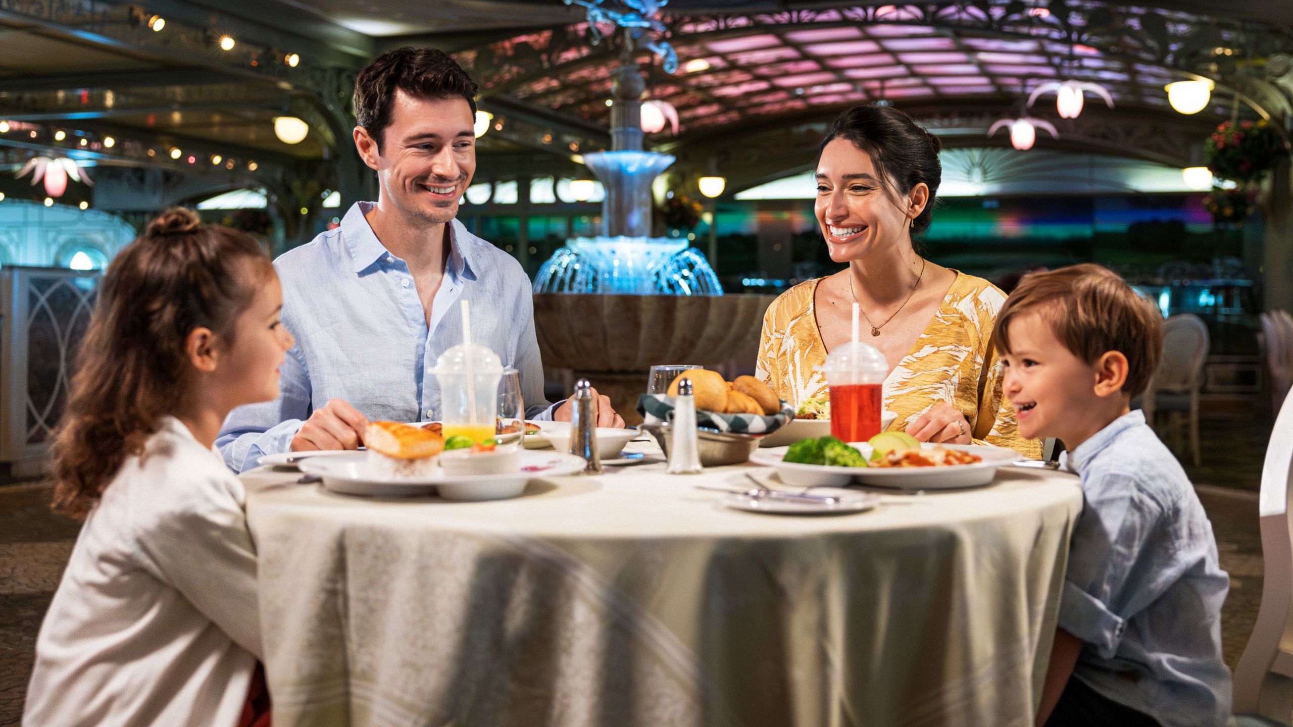 A family eats a meal at the Enchanted Garden restaurant