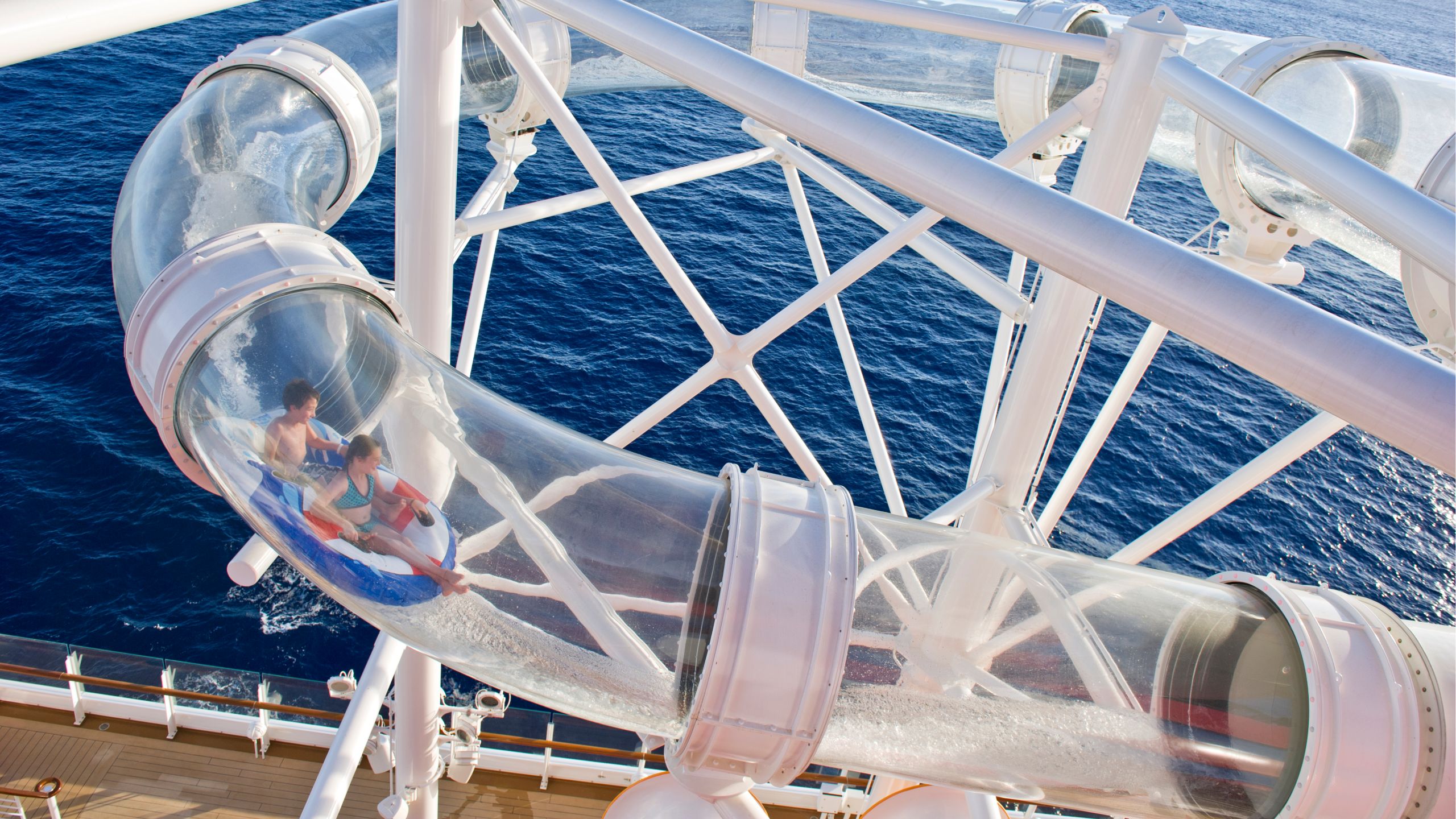 Two Guests riding an inflatable raft down the Aqua Duck water slide