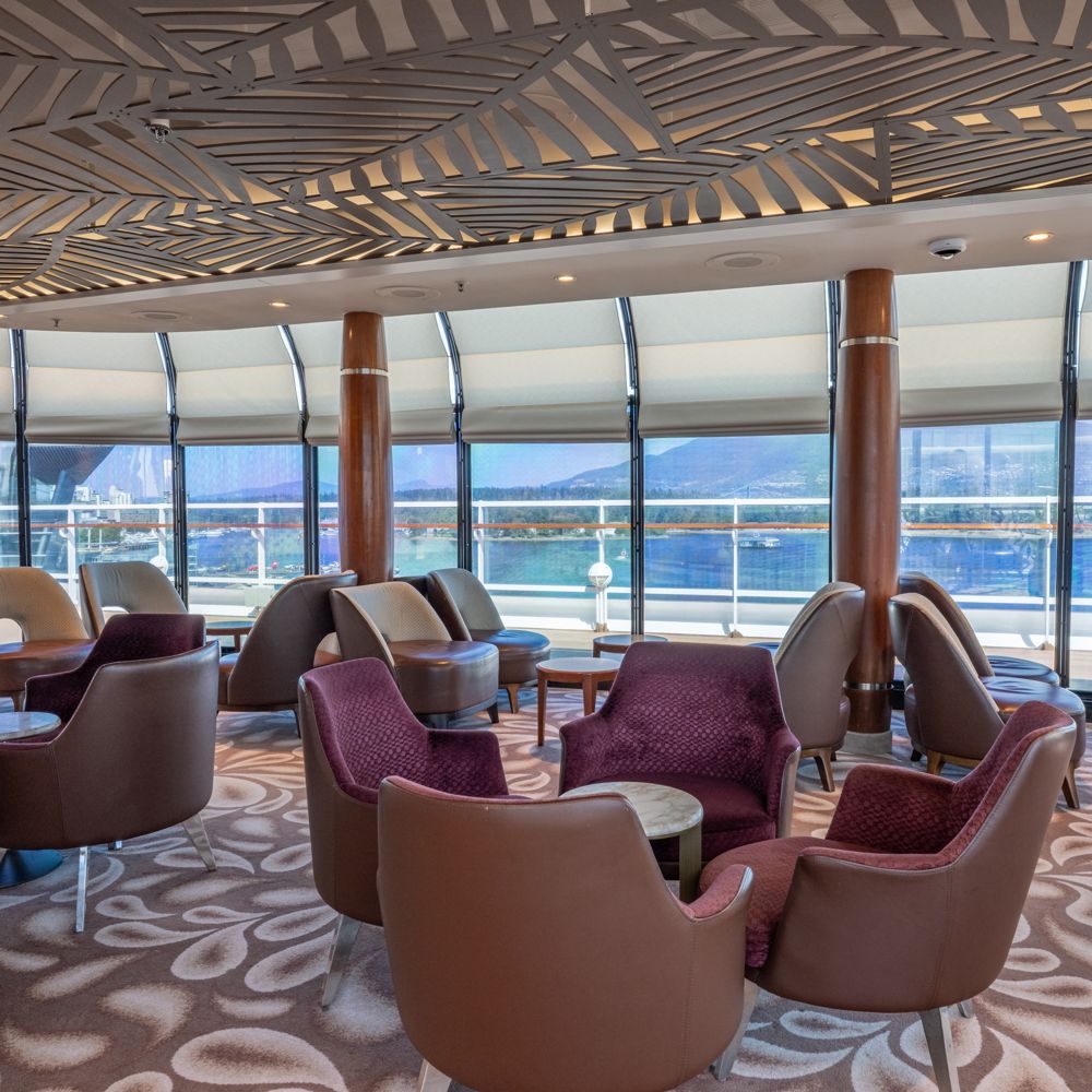 Tables and chairs in the Disney Wonder Concierge Lounge