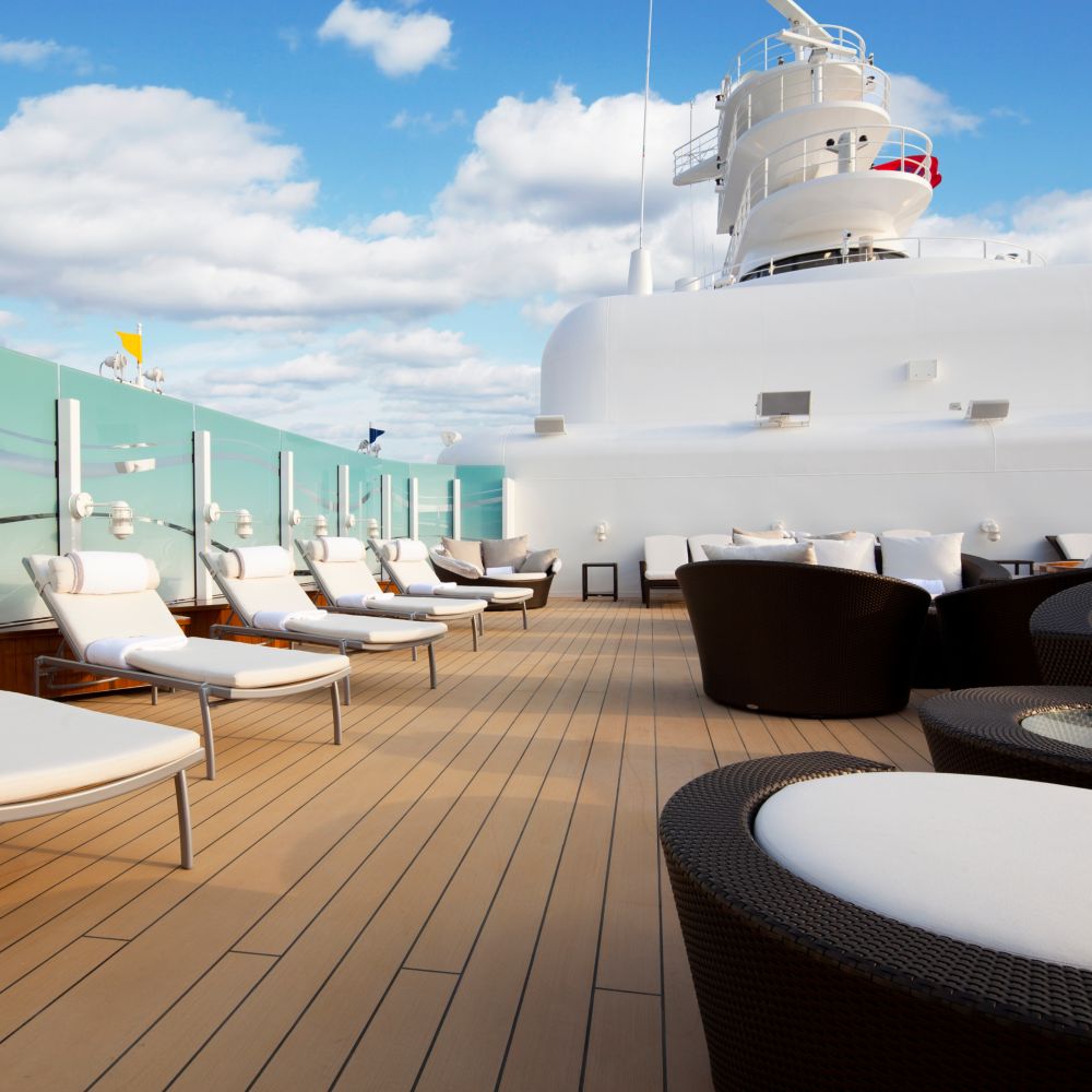 The Concierge Lounge on a Disney cruise ship featuring lounge chairs, sofas and tables