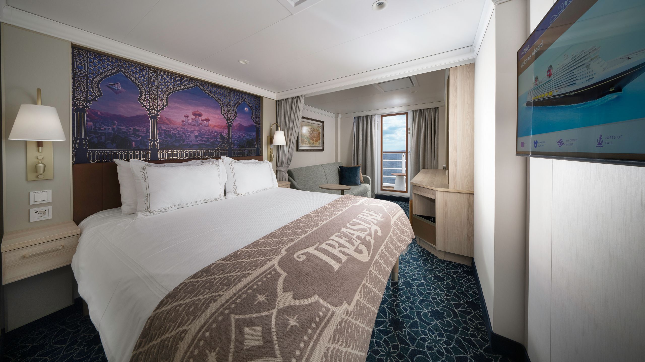 An artist rendering of a Disney Treasure Deluxe Oceanview with Verandah Stateroom with a bed, artwork inspired by Aladdin, a sofa, a verandah with an ocean view, a vanity and a TV