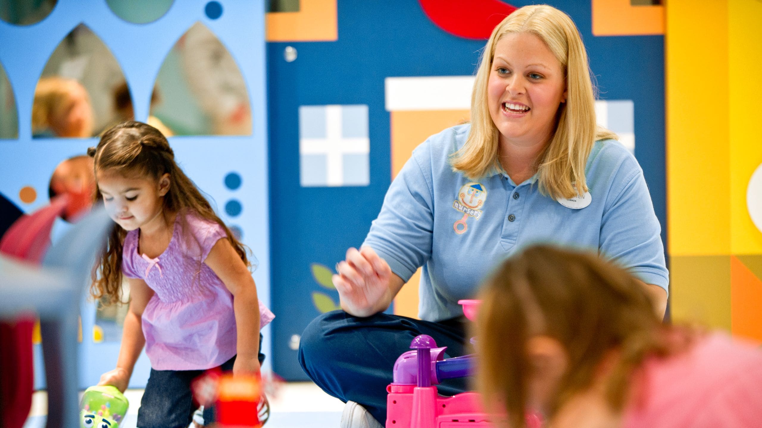 A Cast Member plays with young Guests