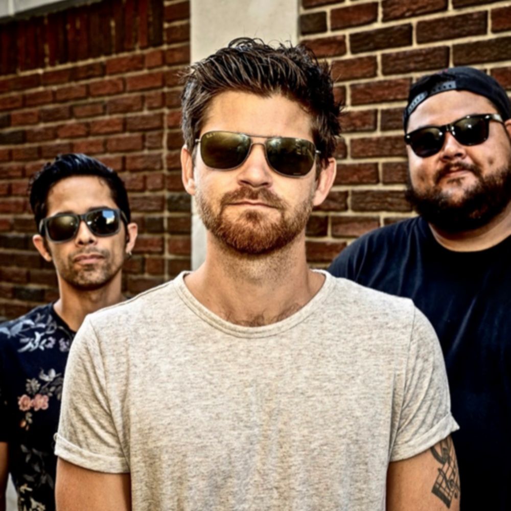 A portrait of the 3 members of the band Haze Over Hollywood