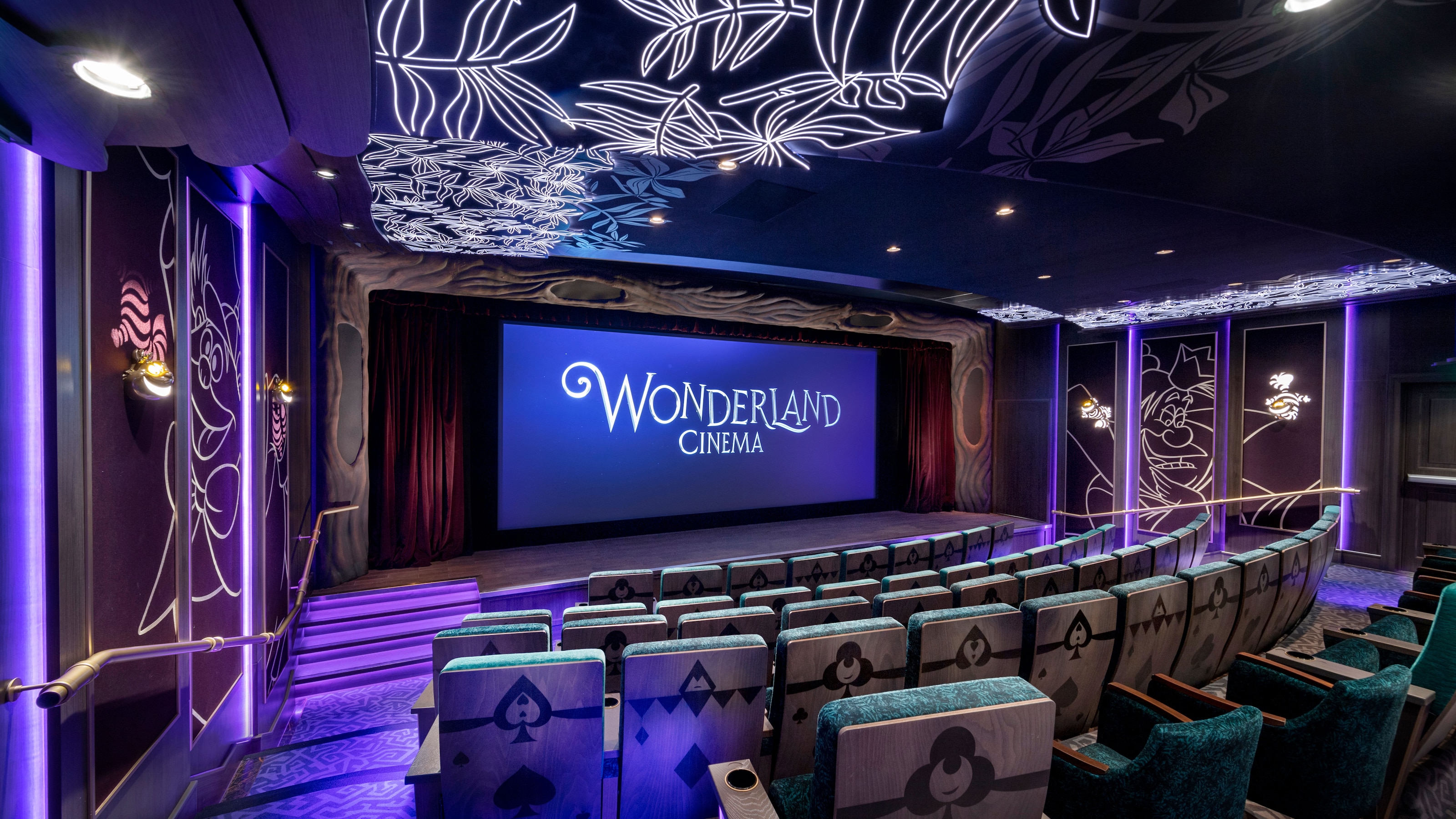 A movie theater aboard a Disney cruise ship with a screen reading ‘Wonderland Cinema’ 