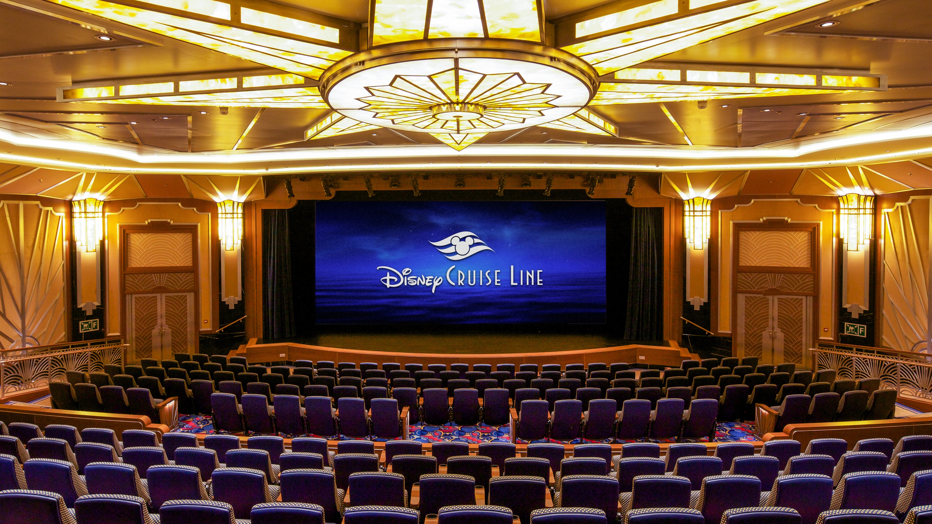 A spacious theater with a large stage and a high curtain