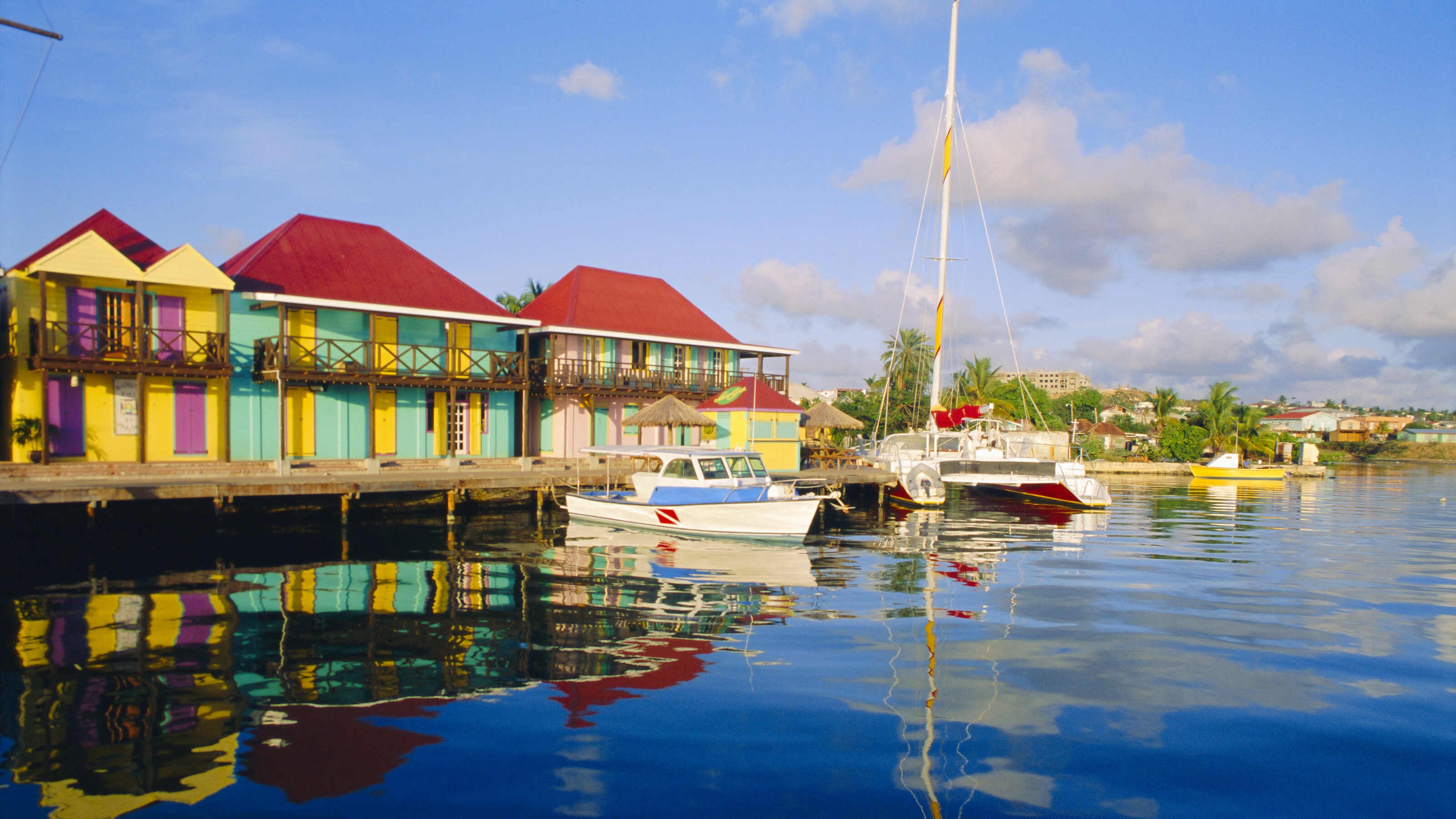 Waterfront shops along a calm boat harbor in Redcliffe Quay, Saint John’s, Antigua and Barbuda